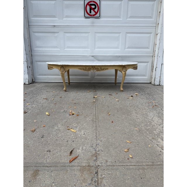 We have an absolutely gorgeous French Louis XV style marble top coffee table for sale. This vintage Rococo Revival coffee...