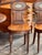 Pair of English hall chairs with shaped seats and oval backs, each centered with a painted and gilt monogrammed oval...