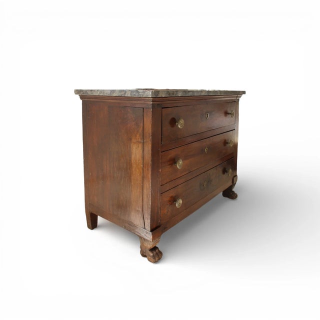 A classic 19th-century French Empire walnut chest featuring clean architectural lines and refined proportions. Topped with...