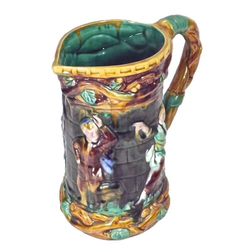 Vintage Majolica festival pitcher with vine handle and spout. Depicts figures dancing and celebrating a festival. No...