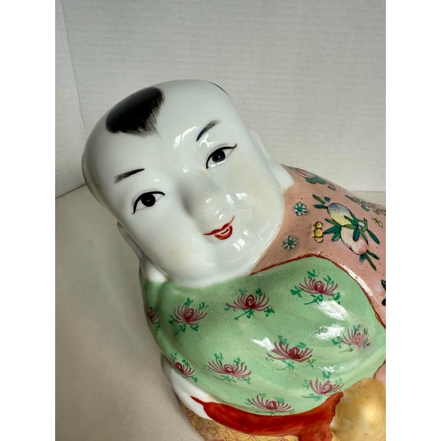 Here is a wonderful mid-20th century Chinese porcelain pillow in the form of a young boy lying down. Hand-painted in the...
