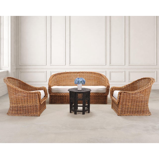 A beautifully crafted suite of three of Italian woven rattan wicker lounge chairs and a sofa made by The Wicker Works in...