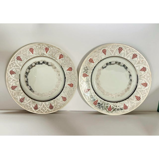 A pair of late 19th century silver gilt dinner plates by Wedgwood featuring a beautiful grape trellis and leaf pattern....