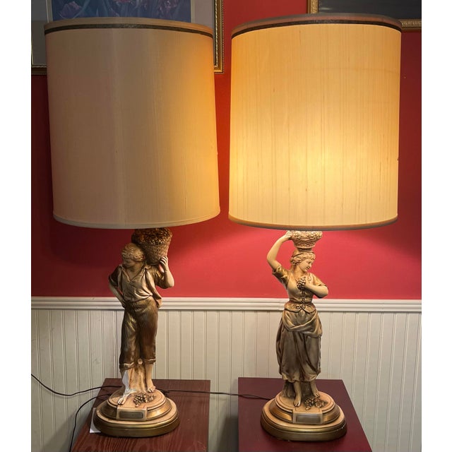 This is a pair of beautiful vintage figural lamps, featuring a young man and a young lady carrying baskets of fruit. The...