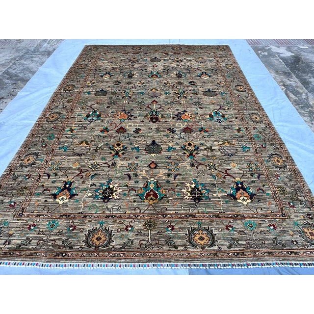 This exquisite hand-knotted wool area rug features a traditional Afghan Sultanabad design with an elegant Chobi styling....