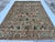 This exquisite hand-knotted wool area rug features a traditional Afghan Sultanabad design with an elegant Chobi styling....