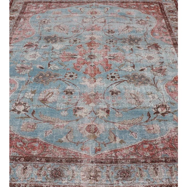This antique Persian Tabriz Khoy rug features an all-over sub-geometric floral design rendered in multicolor, set upon a...