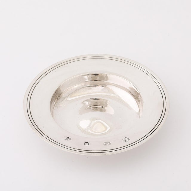 This Art Deco Sterling Silver Dish, signed and hallmarked by renowned designer Theo Fennell, London, dates back to the...