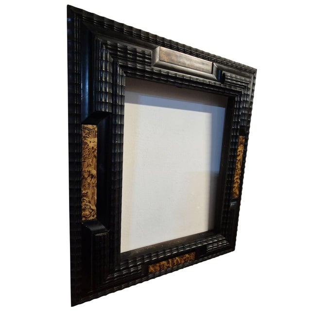 Elegant antique Italian frame crafted from ebonized wood, featuring a refined guilloché decoration running continuously...
