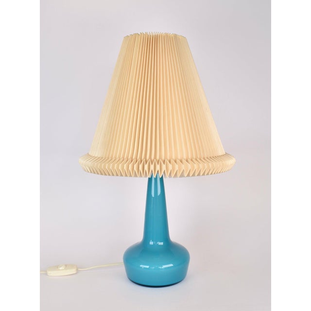 A stunning Le Klint glass table lamp from the 1950s in a rare azure blue color. This lamp was designed by Esbe klint in...