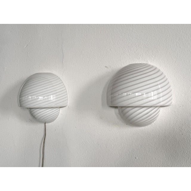 Gorgeous pair of Murano glass wall sconces Made in Italy by De Majo Murano during the 1970s. Every glass is signed by hand...