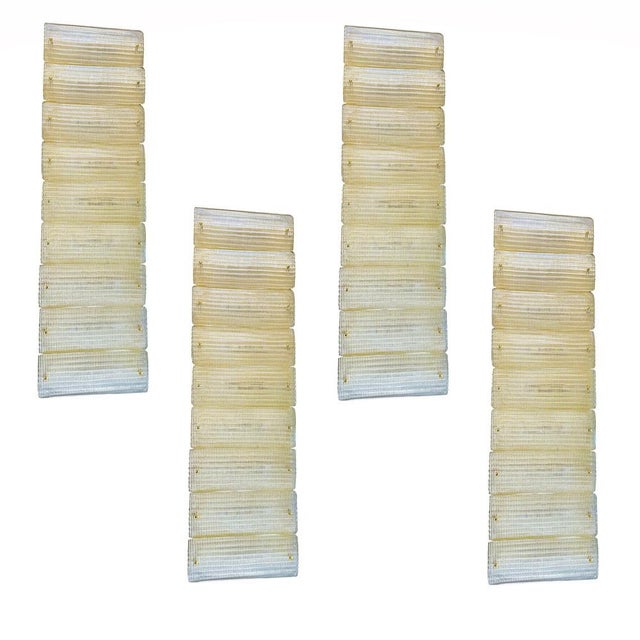 Huge rectangular wall sconce in unlaquered brass and transparent murano glass with a diamanted texture that give brigtness...