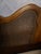 An elegant French Provincial style headboard featuring a serpentine shaped crest rail accented by a carved central shell...