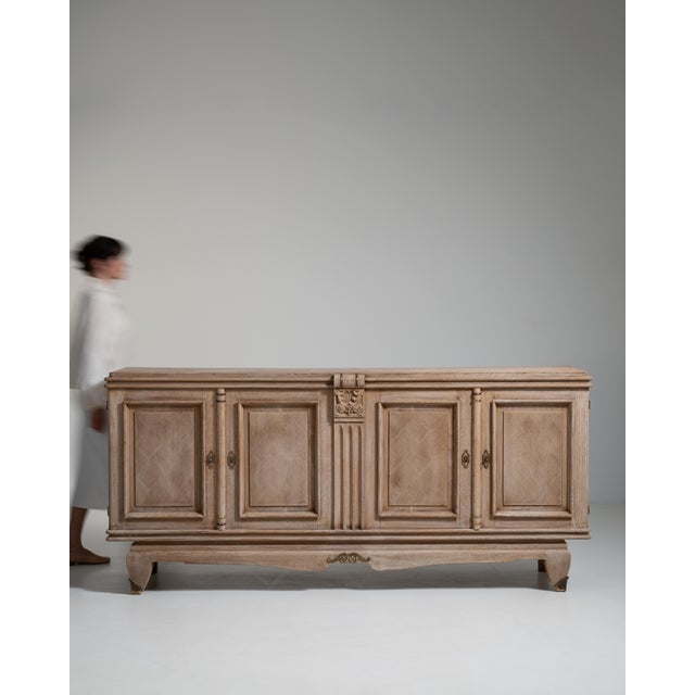Evoking the refined restraint of mid-century French craftsmanship, this circa 1940 buffet is rendered in warm, richly...