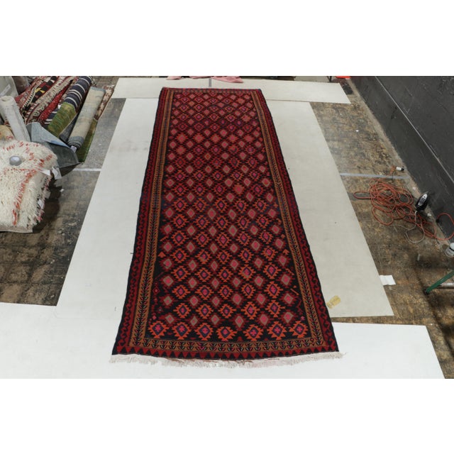 Handwoven in fine wool, a 6x16 vintage kilim rug originating from Turkey circa 1950-1960, now joining our coveted...