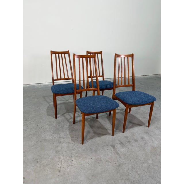 Mid Century Danish Modern Slat Back Teak Dining Chairs. Reupholstered in knoll textured blue fabric, frames previously...