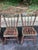 A charming set of four vintage dining chairs featuring a classic faux bamboo form with a beautifully aged, hand-painted...