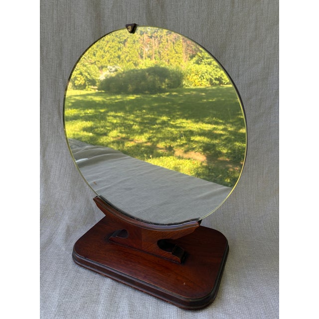 Antique Art Deco free standing, round table top dressing mirror. Round mirror with a simple dark wood base. The mirror has...