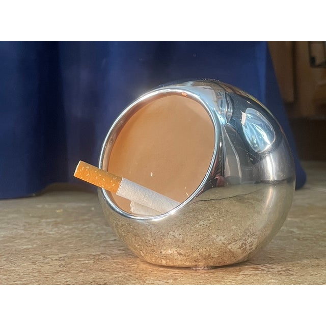 A quintessential piece of Space Age design, this spherical "orb" ashtray captures the retro-futuristic optimism of the...