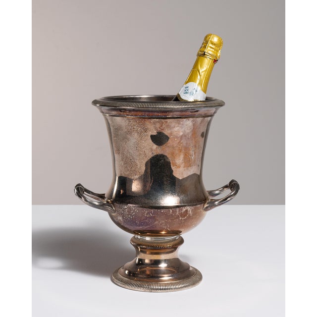 This mid 20th century Neoclassical ice bucket from Spain is finished in silver and gold. It is combining a silvered body...