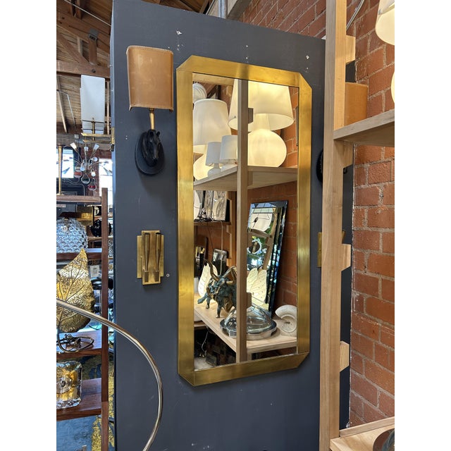 This striking Italian mirror, likely crafted in the 1970s, embodies the bold elegance of the era with its geometric form...