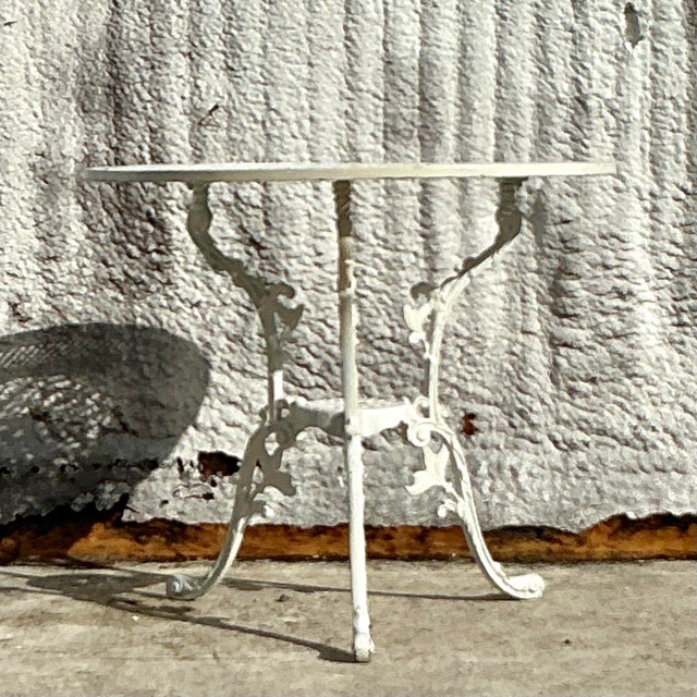 Introduce seaside charm and timeless elegance to your decor with this vintage coastal pierced wrought iron cage table....