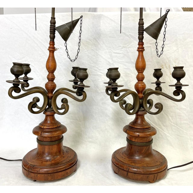 Rustic pair of turned wood with bronze lamps by Chapman Lamps made in Italy. They are made of turned wood, likely mahogany...