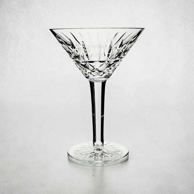 This Waterford Crystal Maeve tall cocktail martini glass was produced in Ireland during the Late 20th Century. Crafted in...