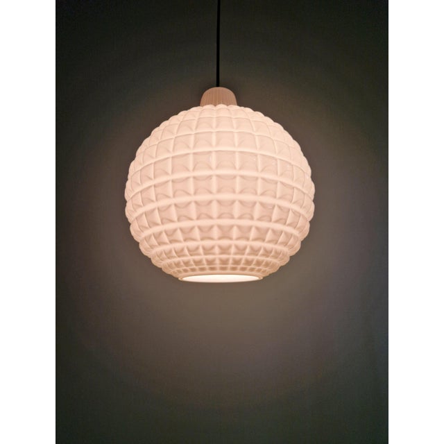 Space Age pendant light in white opaline glass, spherical shape with a textured finish, dating from the 1960s-70s. The...