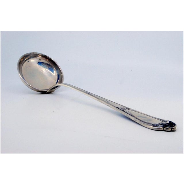 Silver Soup Ladle with Grooves and Monogram Card, in Very Good conditions. Designed 1980 to 1989 This piece has an...