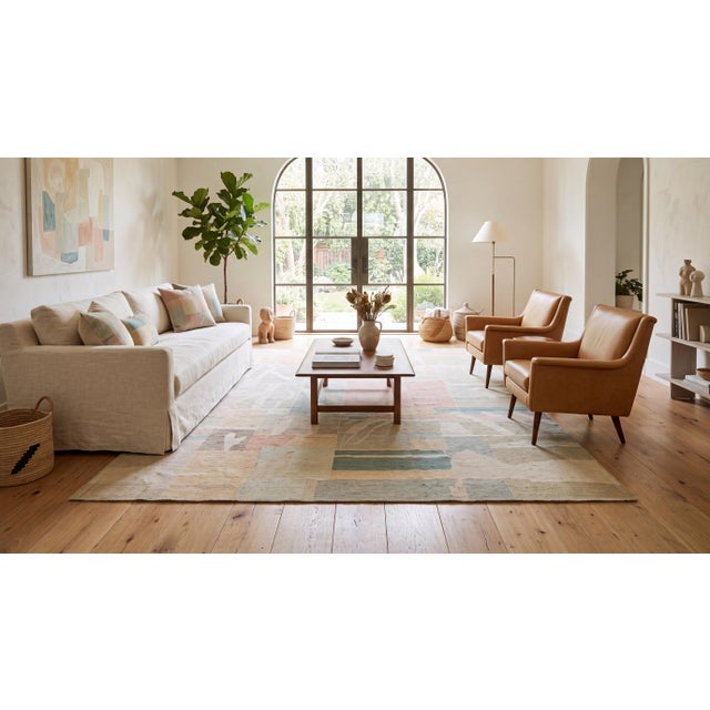 Elevate your interior with this exceptional contemporary hand-woven wool area rug, featuring a sophisticated abstract...
