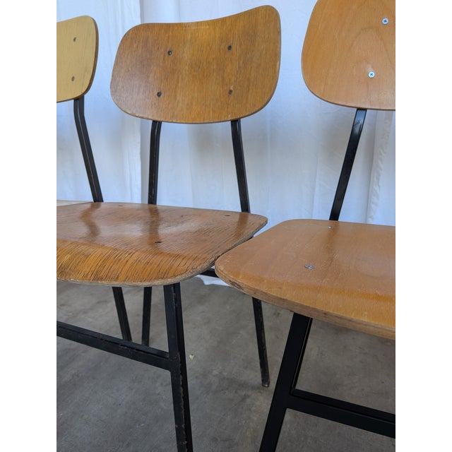 Set of 7 vintage school chairs with a classic mid-century industrial design. The chairs feature a minimalist combination...