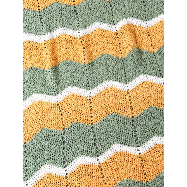 Snuggle up in this vintage handmade crochet afghan featuring a classic chevron / ripple pattern in quintessential 1970s...