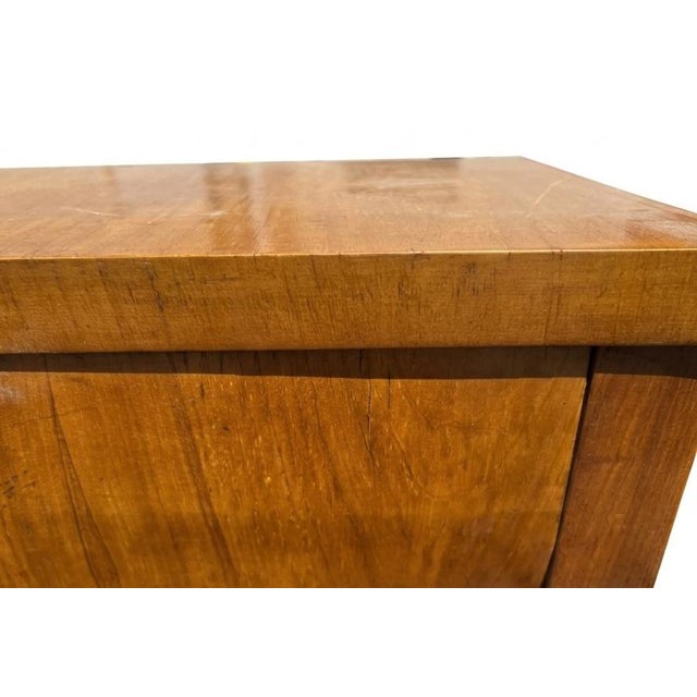This Biedermeier cylinder roll-top desk is a classic example of early 19th-century European furniture design, emphasizing...
