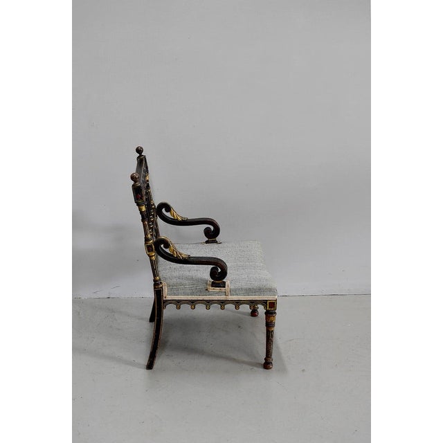 Small Napoleon III armchair in blackened, painted and gilded wood, in its original condition. Its back is carved and...