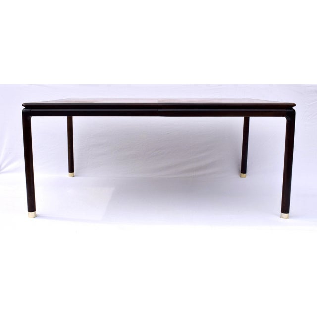 Handsome extendable dining table by John Stuart boasting stunning banded Mahogany & book-matched flame walnut top. Classic...