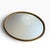 Elegant vintage oval mirrored vanity tray featuring a beautifully detailed braided rope-style metal border in a warm...