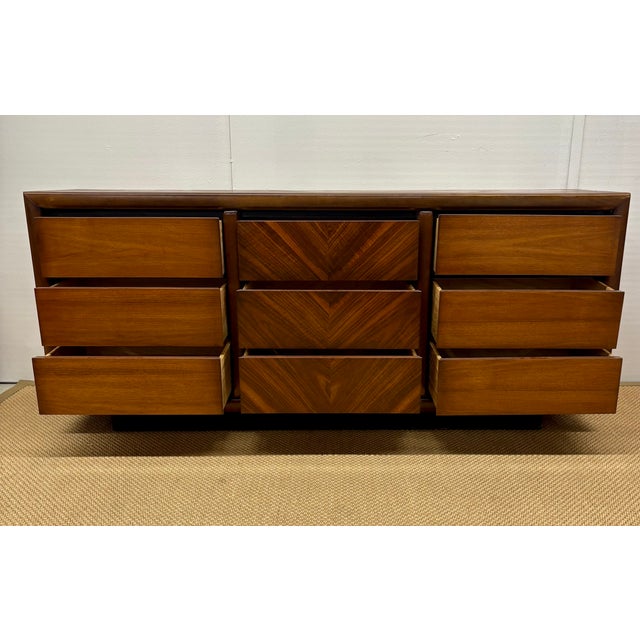 Mid-Century Modern dresser by Lane Furniture with distinctive book-matched rosewood or walnut veneer on the center...