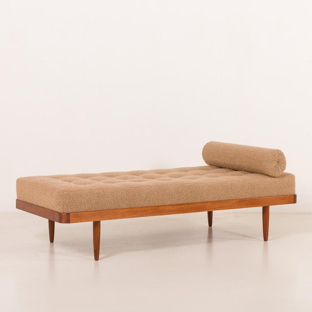 This scandinavian mid-century modern daybed was crafted in denmark in the 1960s. This piece features a teak frame paired...