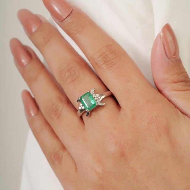 This elegant 925 Sterling Silver Natural Emerald and Diamond Ring showcases a beautiful natural emerald measuring 6 x 8...