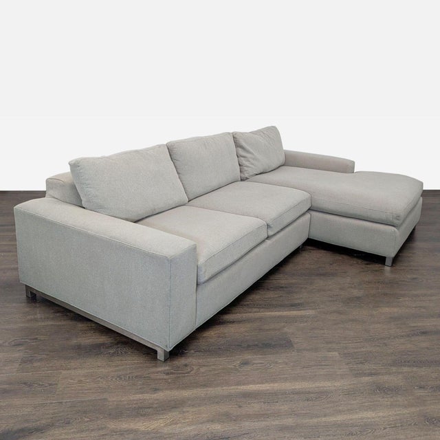 This Room & Board sectional features a clean, modern look in a light neutral fabric. It includes a spacious right-facing...