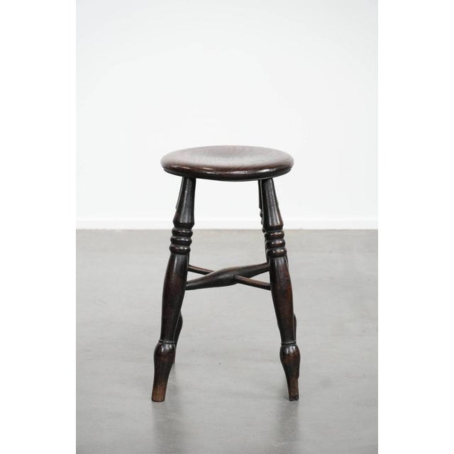 We are offering this English antique classic and timeless Windsor stool from the 18th century with character and a...