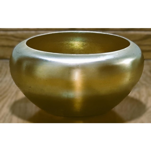 A luminous and beautifully preserved Steuben Gold Aurene Rolled Rim Bowl, shape No. 2687, created during the highly...