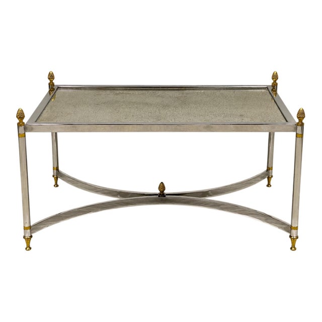 This is a late 20th century Maison Jansen inspired chrome and brass coffee table with a distressed mirror top. The...