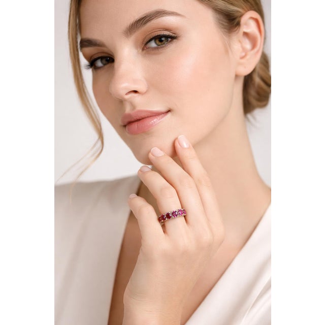 Elegant 14K white gold eternity band set with 17 oval-shaped rubies totaling approximately 9.97 Carat Total Weight,...