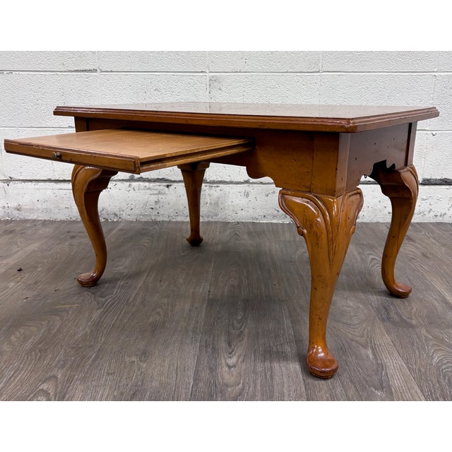 This is a charming vintage Queen Anne style coffee table featuring a warm wood finish, decorative parquet-style top,...