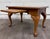 This is a charming vintage Queen Anne style coffee table featuring a warm wood finish, decorative parquet-style top,...