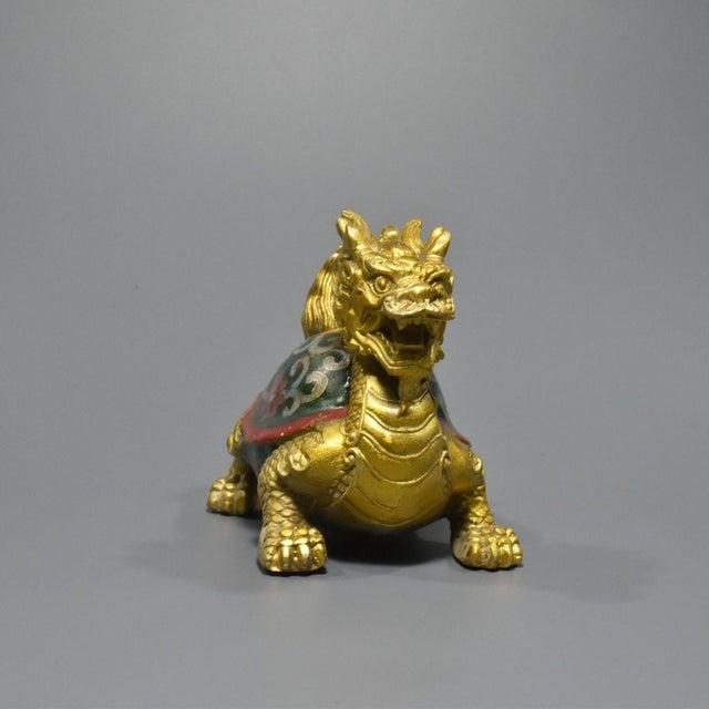 This charming sculpture depicts a dragon-turtle (Longgui), a traditional symbol of longevity, stability, and wisdom. The...