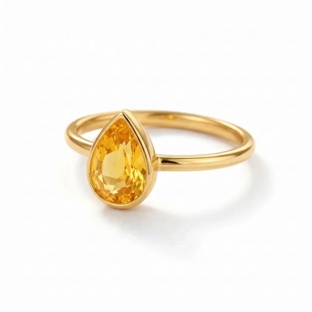 Pear Citrine Solitaire Ring in Gold Radiant and uplifting, this ring features a glowing pear-shaped citrine set in a...