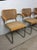 This set of three mid century modern dining chairs in the style of Marcel Breuer feature chrome chair frames with hardwood...